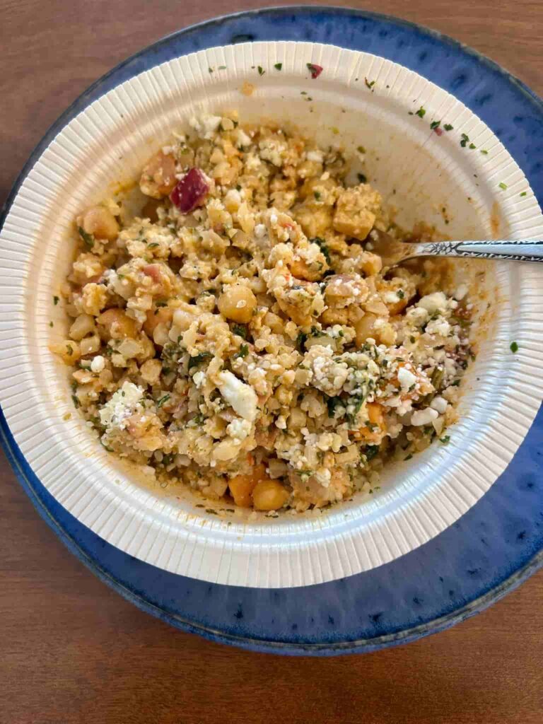 Goat cheese and hemp hearts mixed into bowl