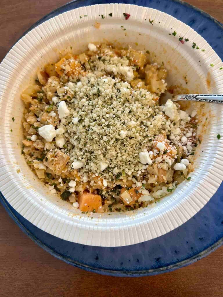 Goat cheese and hemp hearts on top of bowl